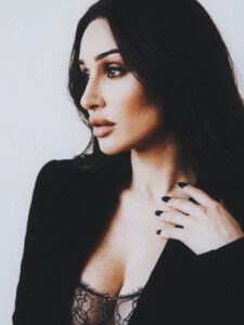 Profile portrait of Aylin Baykal wearing a black blazer and lace bodysuit for Starchuska Women’s AW’26.